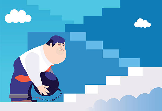 istock businessman with ball and chain beside stairway 2213998699