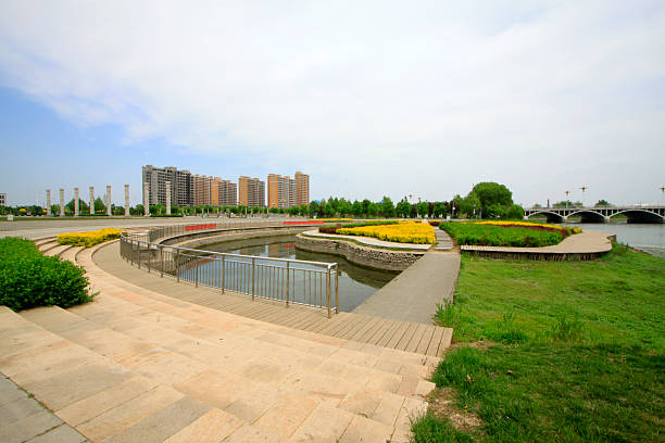 istock Urban construction scenery, pond and stainless steel rail 2213998700
