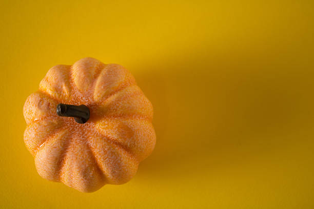 Autumn pumpkins on a yellow tablecloth ready for Halloween