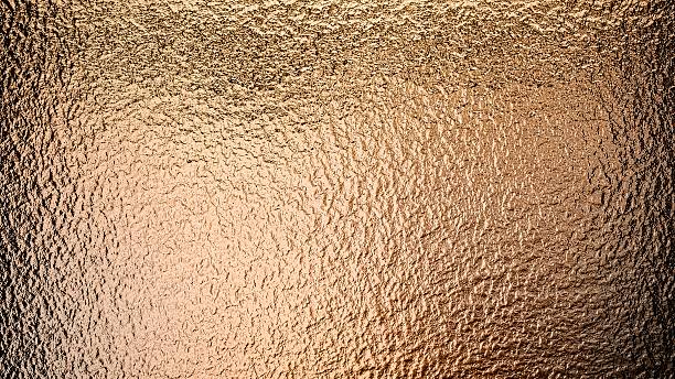 istock Grainy copper foil texture bronze color metal surface close up view background 2214002493