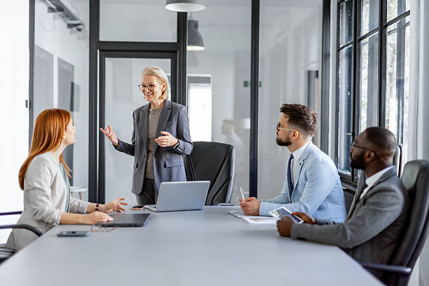 istock Professional woman presenting ideas to a business team 2214002558