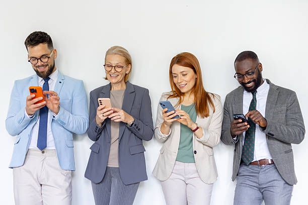 istock Group of professionals using phones and engaging with tech 2214002598