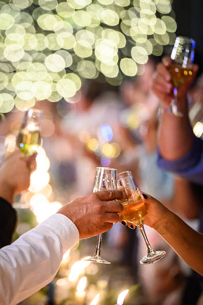 istock Group toasting glasses during festive celebration with glittering bokeh lights 2214003123
