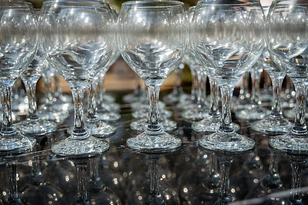 istock Many empty clean wine glasses on dark background in daylight 2214003478