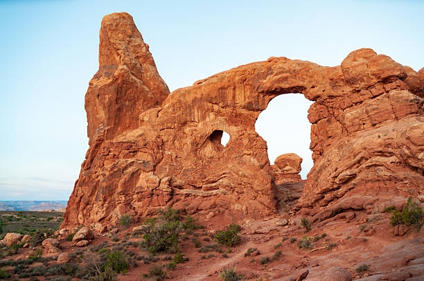 Elephant Arch, unique sandstone formation in Arches National Park Utah under bright sky.