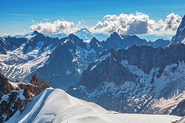 Aiguille du Midi peak in the Alps. Chamonix valley landscape of a prominent rocky towering mountain peak in French Alps. Chamonix-Montblanc area beautiful landscape of Aiguille du Midi summit, France