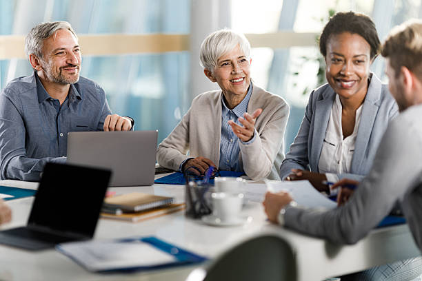istock Happy entrepreneurs talking during a constructive meeting in the office. 2214005424