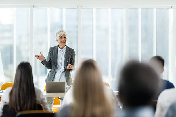istock Happy female CEO giving a presentation in board room. 2214005903