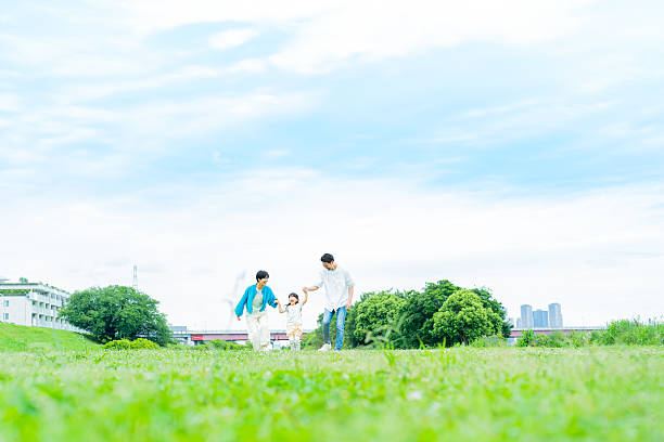 istock family playing in the park 2214006515
