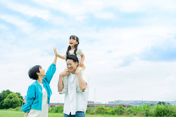 istock family playing in the park 2214006517
