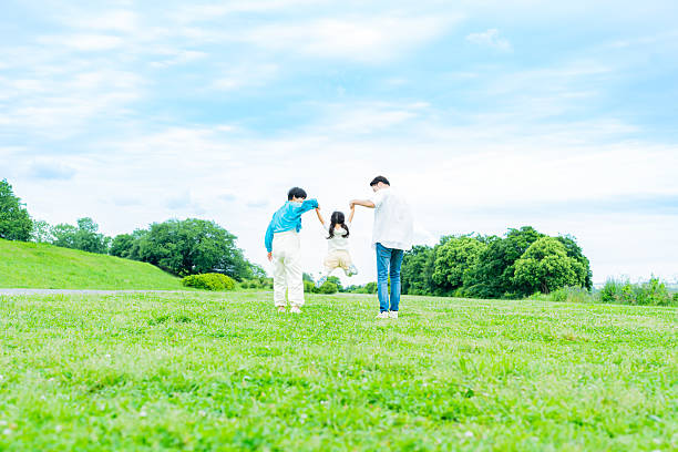 istock family playing in the park 2214006519