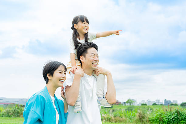 istock family playing in the park 2214006521