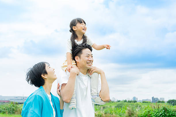 istock family playing in the park 2214006522