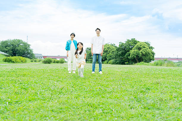 istock family playing in the park 2214006534