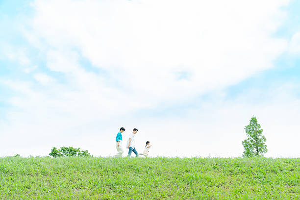 istock family playing in the park 2214006541
