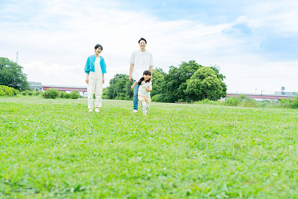istock family playing in the park 2214007799