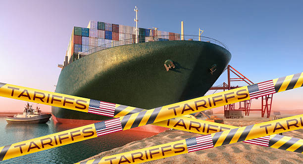 istock Container ship at port blocked by U.S. tariff tape. 2214008635