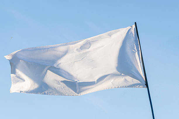 istock White flag waving against a cloudy sky, slightly tattered captured in naturalistic style outdoors, diffuse daylight a 2214009245