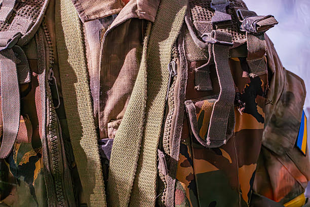 istock Close-up of camouflage-patterned military individual worn uniform, backpack, soft angled lighting, isolated subject a 2214009306