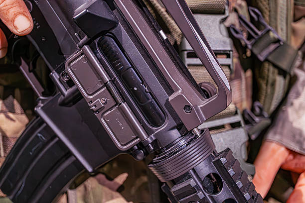 istock Close-up image of hands maintaining a firearm, tactical gear in background Preparedness scenario, likely military or law enforcement Detailed, realistic photography style 2214009464