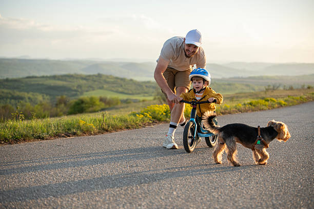 istock Father teaching son to ride a bicycle. 2214009951