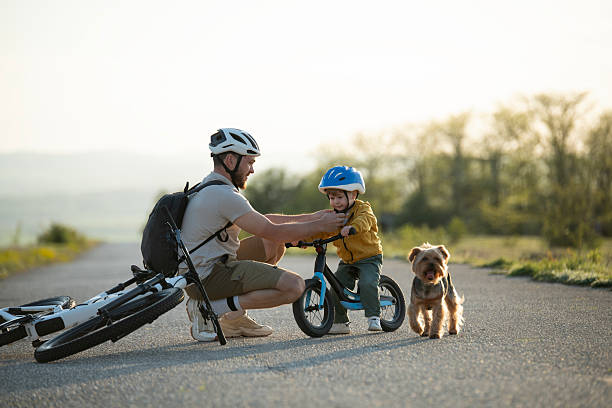 istock Family preparing for cycling on the road. 2214009983