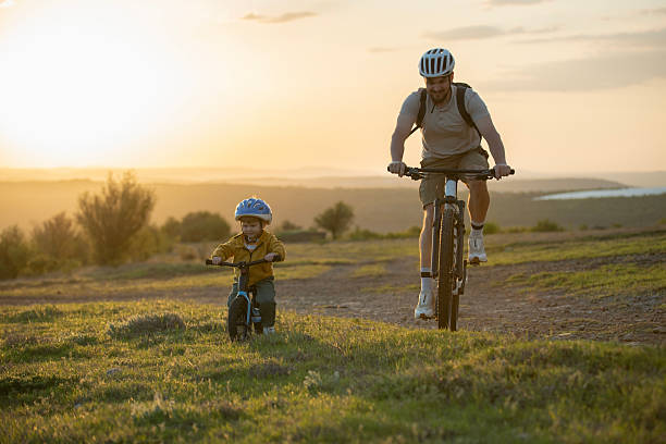 istock Father and son riding bikes together. 2214009995