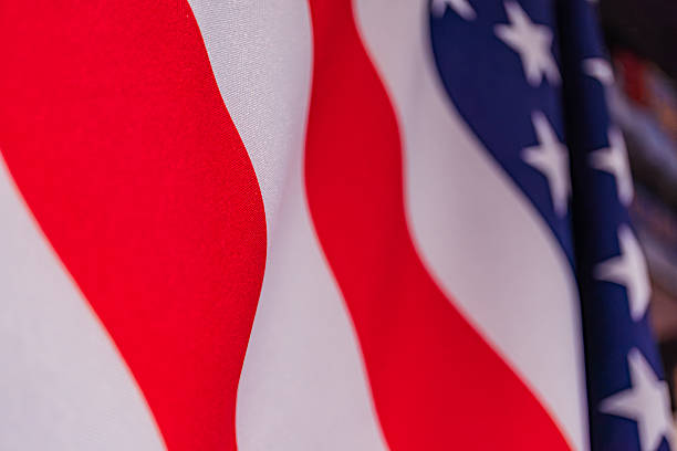 istock Close-up, American flag, waving, indoor setting, soft shadows, ambient light, realistic style, no text, blurred background a a 2214010662