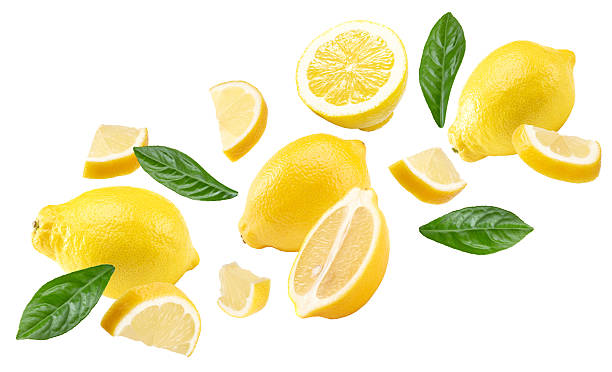 istock flying lemons with leaves isolated on white background. clipping path 2214012775