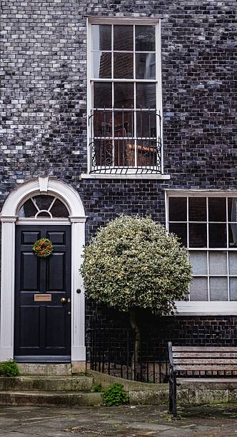 istock Charming historic building facade with black door. 2214012873
