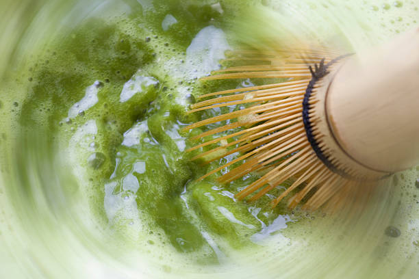 Matcha mixed with a bamboo whisk