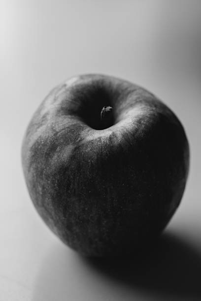 A close-up image of a fresh red and green apple with a smooth surface on a white background. High quality photo