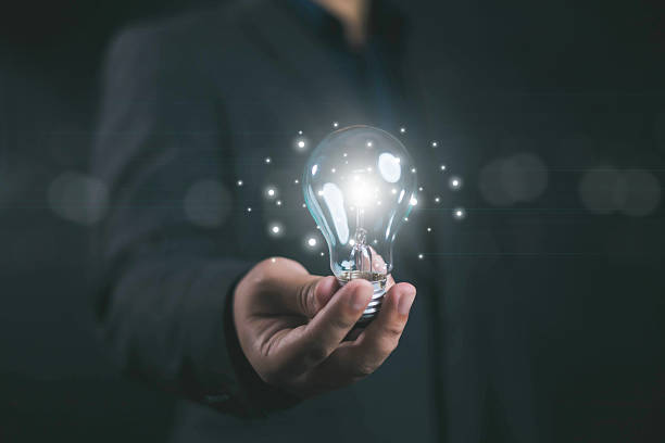 istock Idea innovate and concept. Businessman holding a light bulb that shine glitter, creative thinking concept success, management and digital transformation, data search, thinking 2214015174