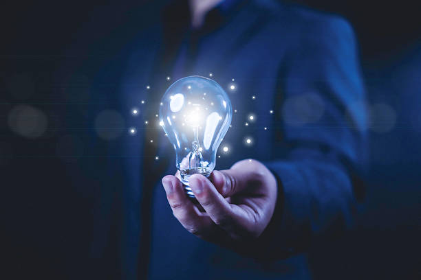 istock Idea innovate and concept. Businessman holding a light bulb that shine glitter, creative thinking concept success, management and digital transformation, data search, thinking 2214015184