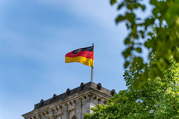 Close-up of German flags fluttering over the Reichstag. German flags against the sky.