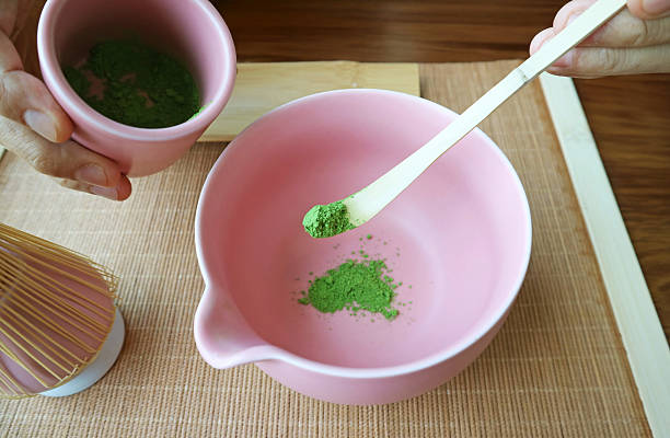 istock Scooping Matcha Tea Powder with Bamboo Tea Scoop Called CHASHAKU for Making Green Tea 2214018391