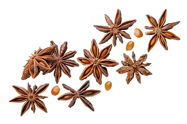 istock Star anise and seeds flying close-up on a white. Isolated 2214020978