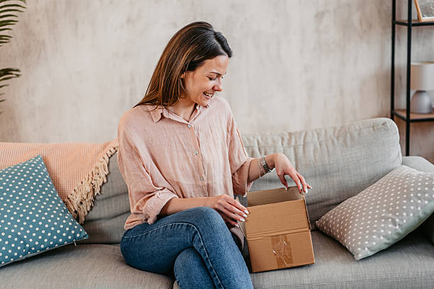 istock Young Woman Unboxing A Package She Ordered Online 2214023529