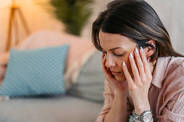 istock Sad Young Woman Sitting At Home On The Sofa 2214023866