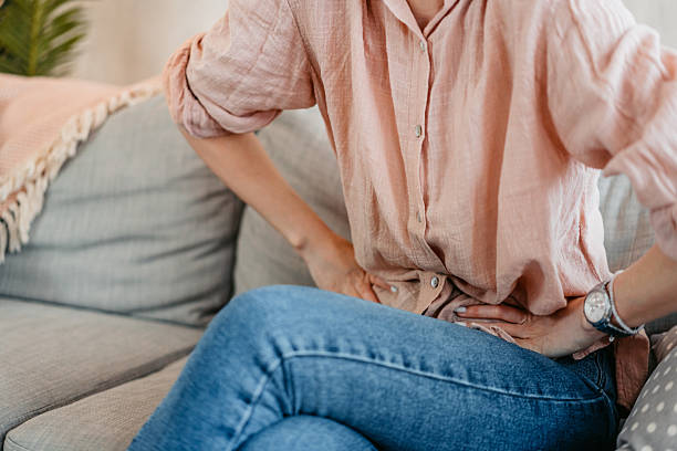 istock Young Woman Having A Stomachache At Home 2214023898