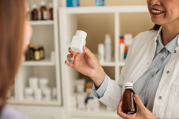 istock Pharmacist recommending products to a customer in a pharmacy 2214024336