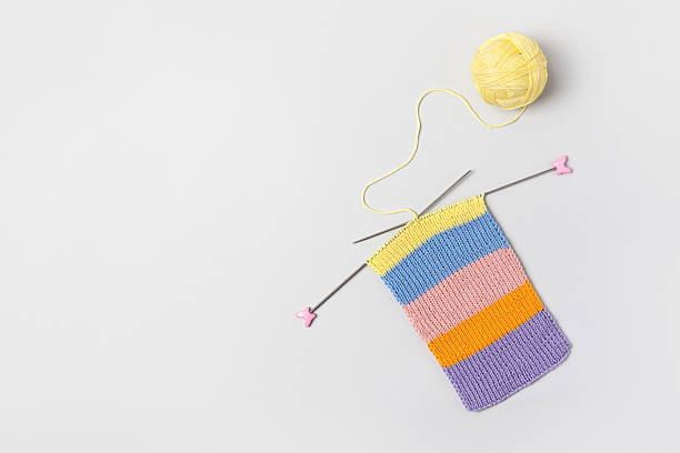 istock Ball of thread with knitting needles and knitted fabric 2214024816