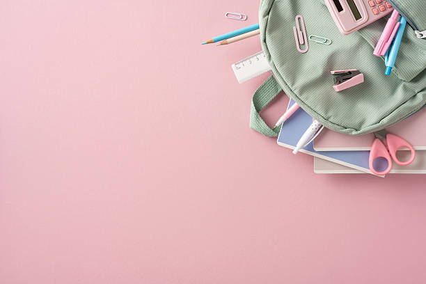 istock A neatly arranged flat lay of school essentials with a backpack positioned on a pink surface 2214025657