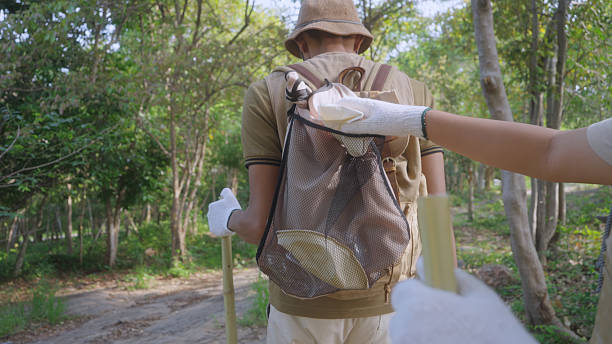 istock Eco-Friendly Family Collecting Trash During Forest Hike 2214026228