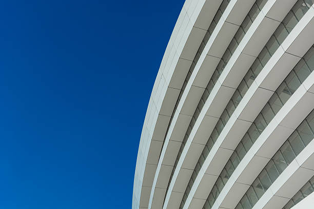 istock Sleek Curves and Blue Skies: A Modern Architectural Marvel 2214027073