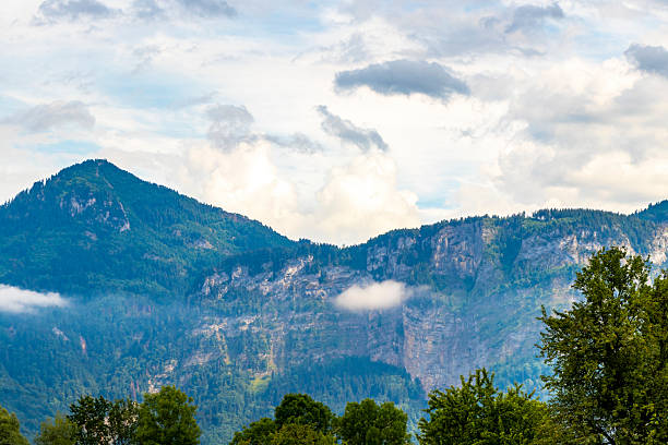 istock Mountain landscape mountains green fields forest clouds in Vorarlberg Austria. 2214027975