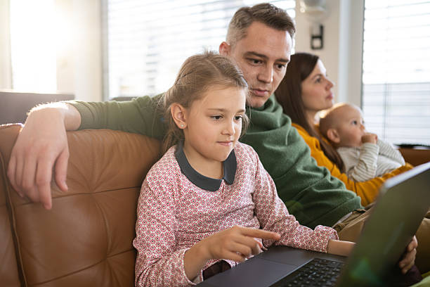 istock Young Family Bonding With Technology in Cozy Living Room Setting 2214031268