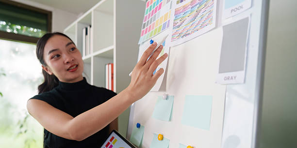 istock Color Theory and Visual Design. A designer presents ideas on a mood board during a creative meeting. 2214033001