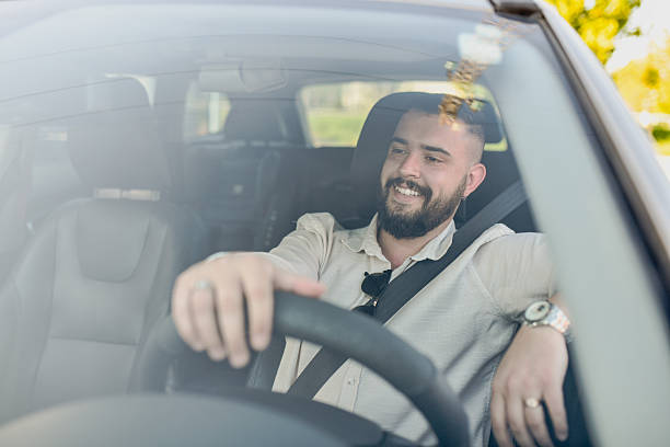 istock Relaxed Driver in Trendy Vehicle With Window Down on Scenic Road Trip 2214036332