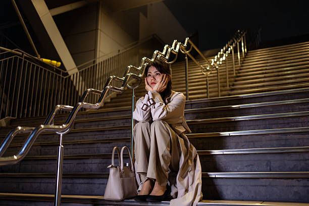Businesswoman sitting on steps after work